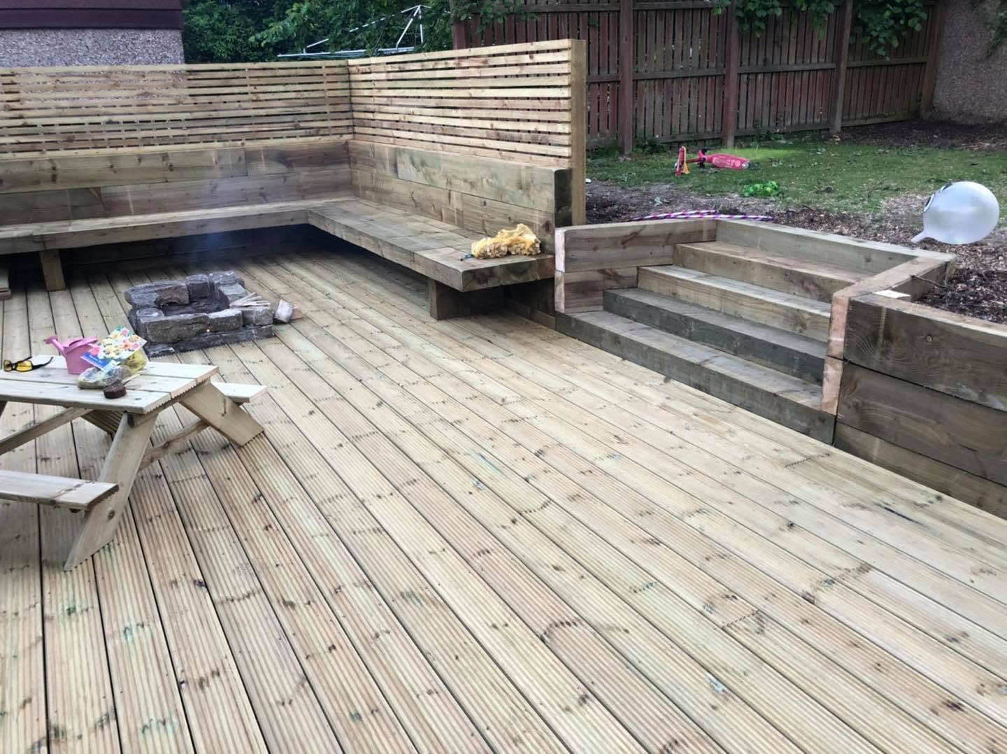 Completed timber decking with built-in seating, steps and planters