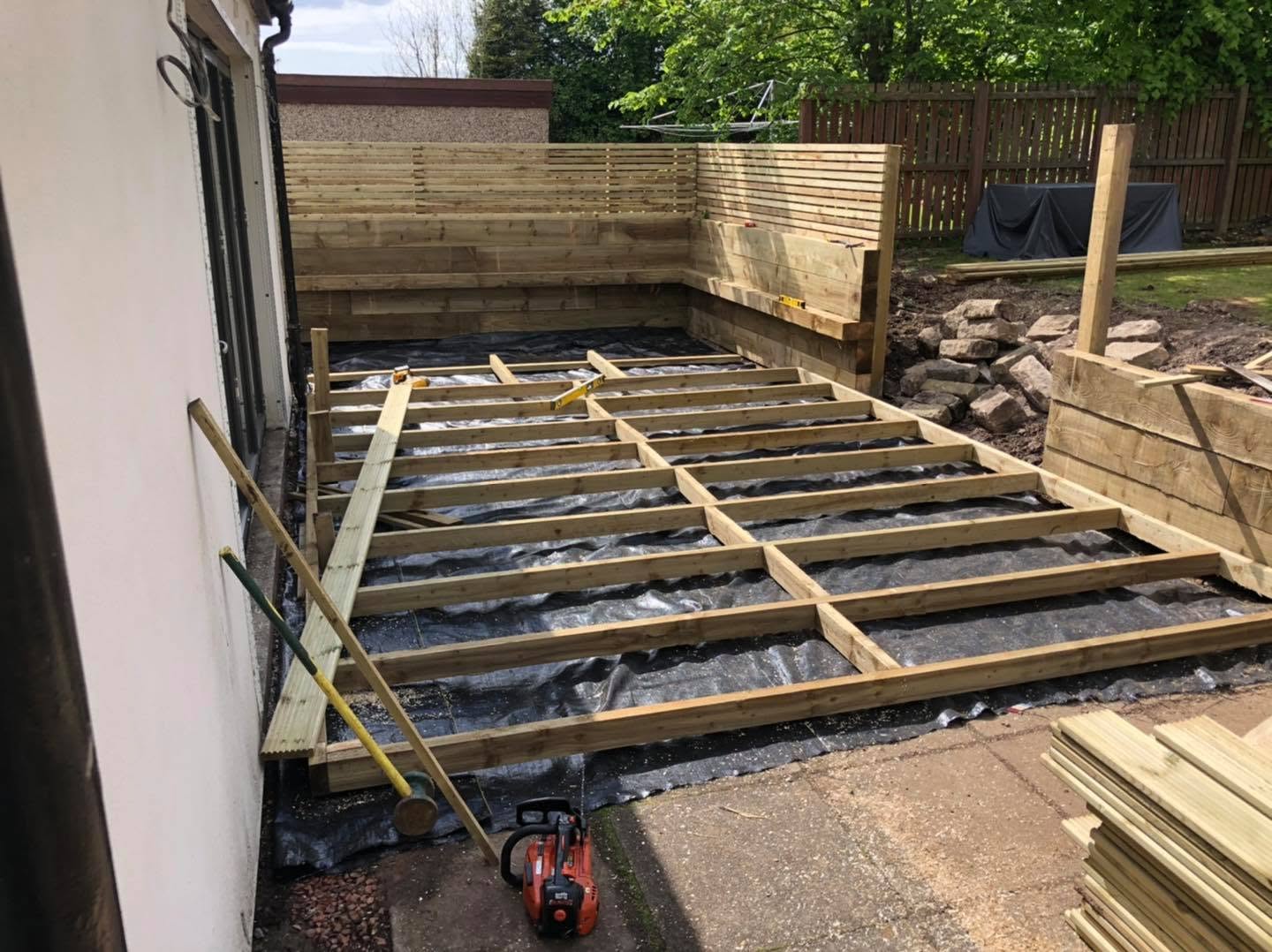 Timber deck frame built over membrane with slatted screening behind