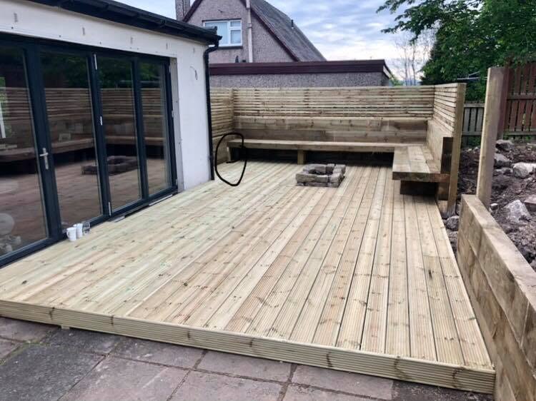 Decking boards laid beside patio doors as the build progressed