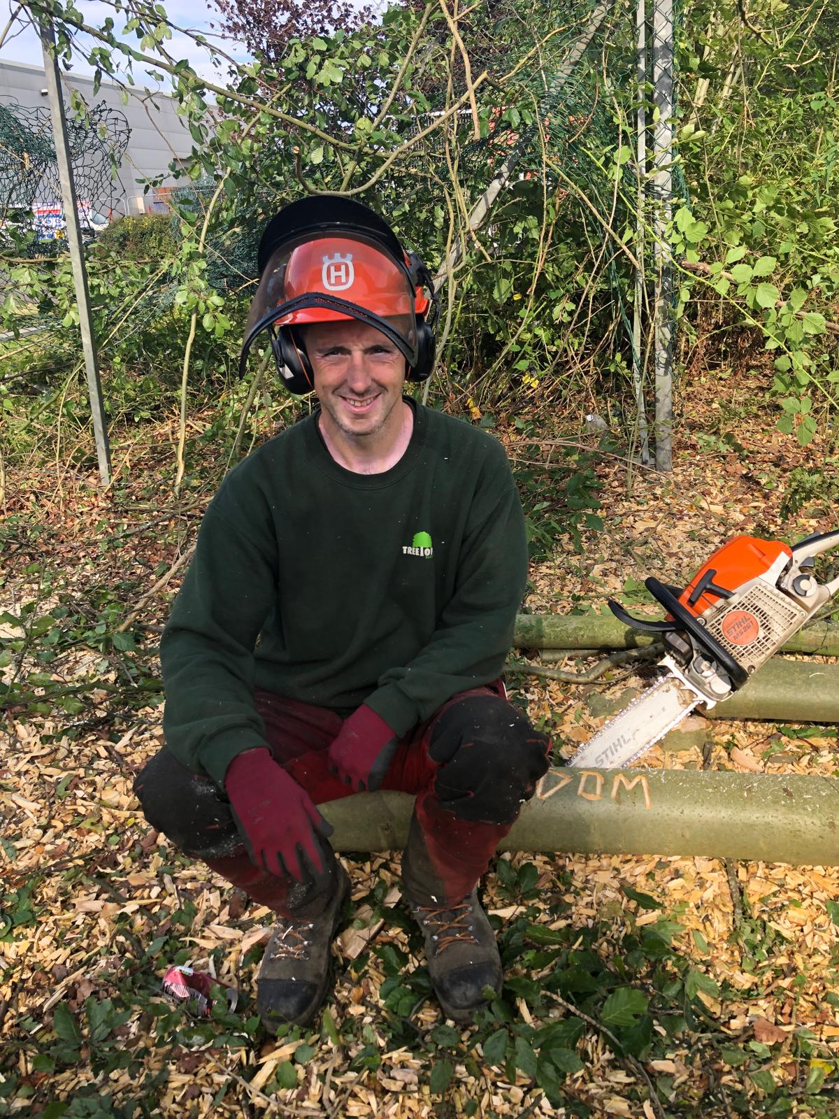 Dominic from Treetop Tree Surgeons wearing safety helmet and chainsaw gear