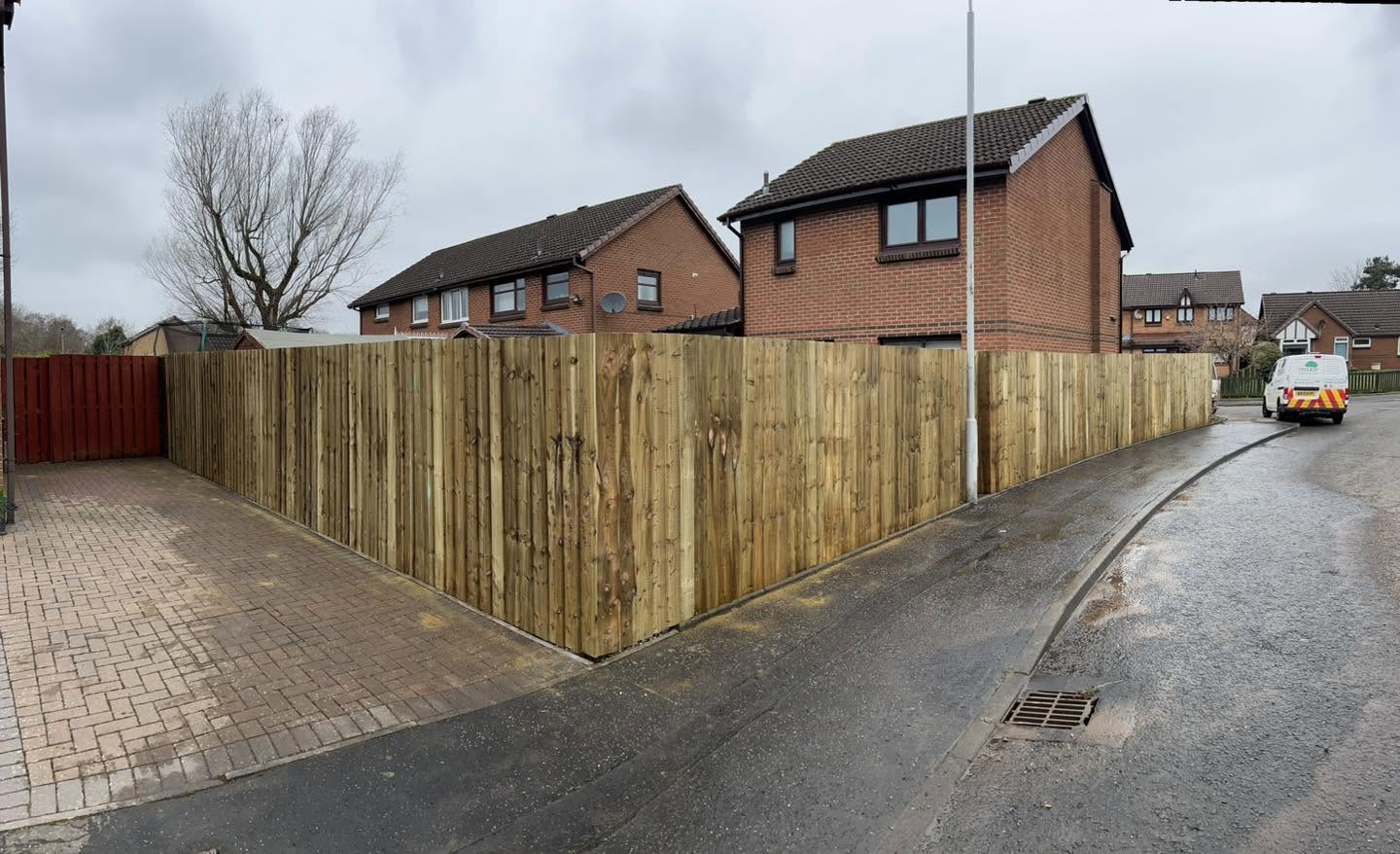New close-board fence run along a corner plot on a residential street